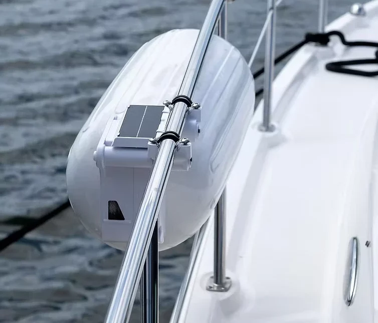 Solar-powered automatic Bluetooth boat fender deployment unit mounted on a boat rail